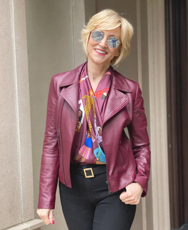 Burgundy leather jacket on woman over 50