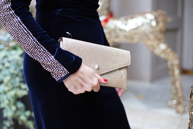 what to wear to a winter wedding - velvet dress and gold clutch