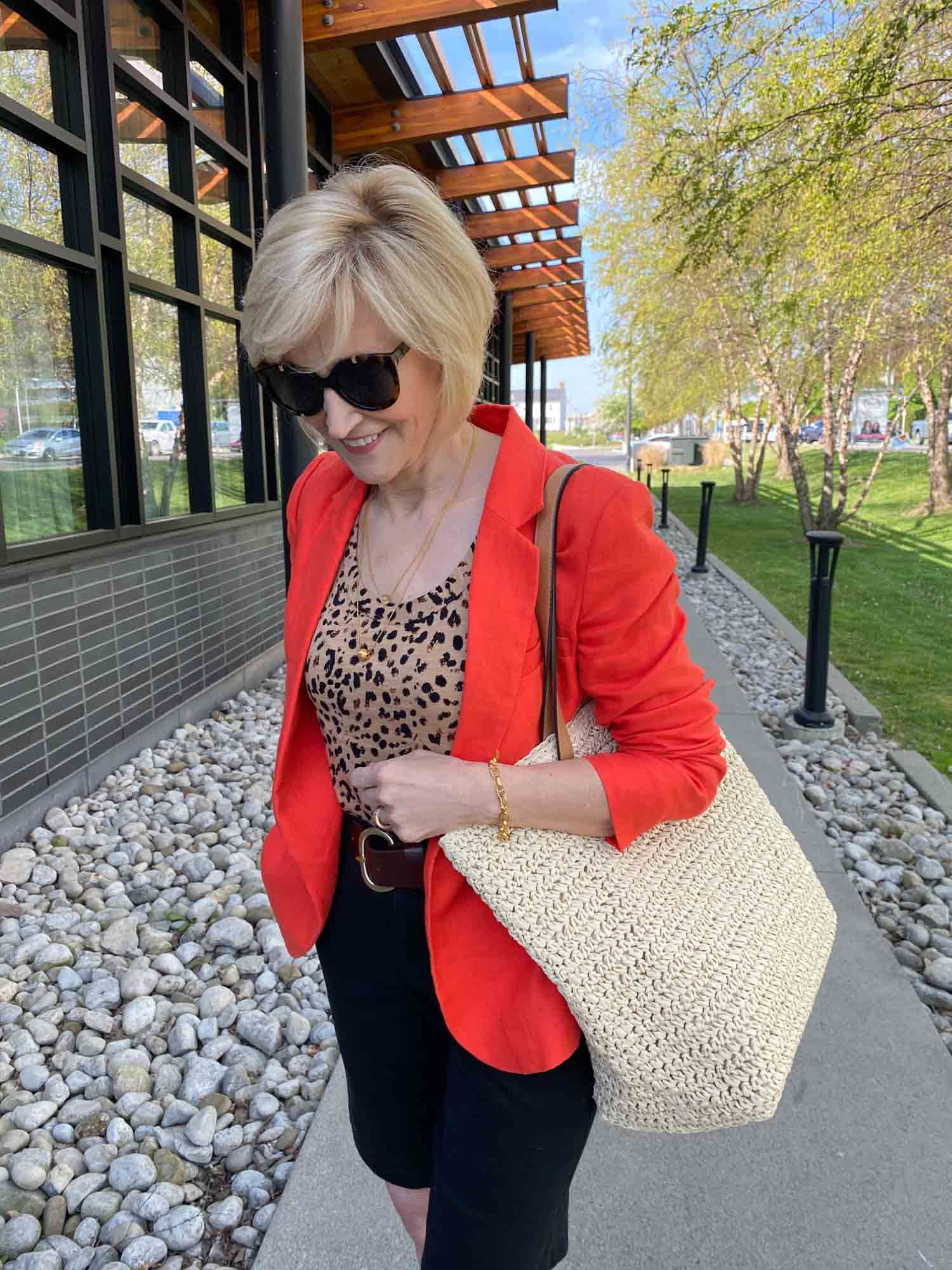 how to style a woven bag - shorts and an orange linen jacket