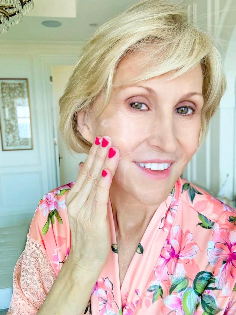 woman cleaning her face woman cleaning her face