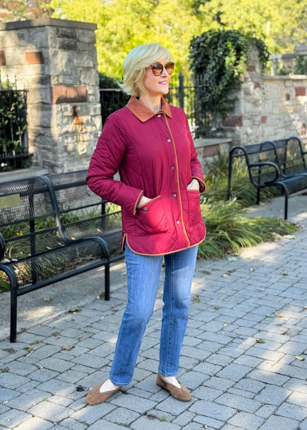 A WOMAN WEARING A QUILTED BARN JACKET FOR FALL